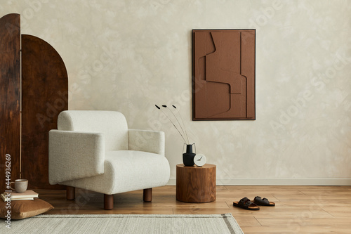 Stylish composition of modern cozy living room interior with structure painting on the wall, beige armchair, folding screen and personal accessories. Creative wall, carpet on the floor. Template.