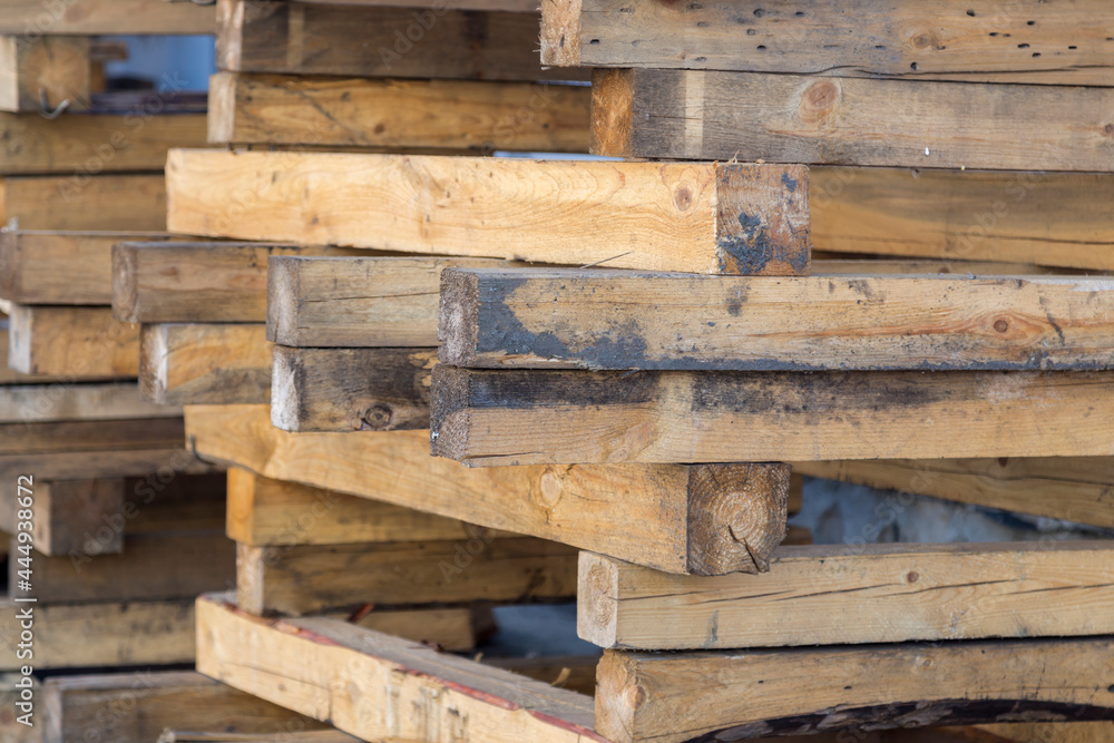 Stacked old untreated used timber with traces of mortar and bent nails Stacked old untreated used timber with traces of mortar and bent nails