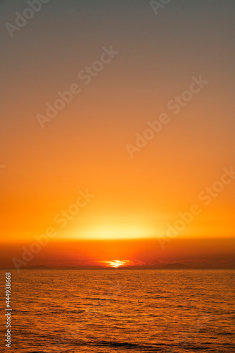 Fototapeta Naklejka Na Ścianę i Meble -  A sunset over a body of water