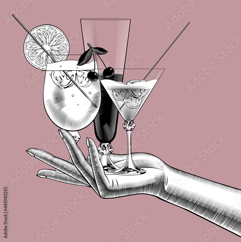 Female hand holding wine glasses with cocktails