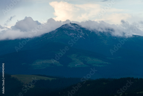 Lonely mountain behind the clouds