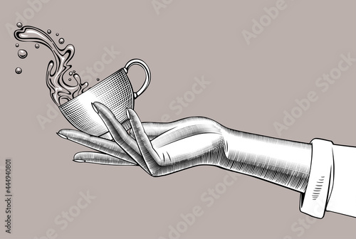 Woman's hand holding a Coffee cup with a splashed water