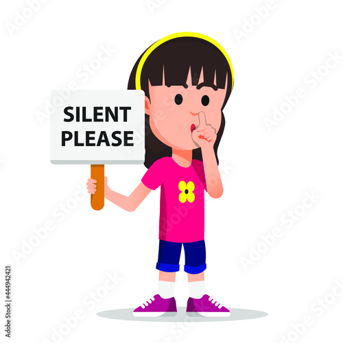 little girl holding a sign telling silence