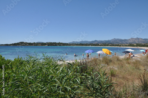 People enjoying the day at Lu Impostu beach on the island of Sardinia in Italy photo