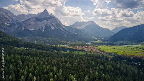 Canvas Print View of high rocky mountains and green dense forests on a sunny day