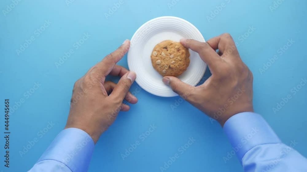hand pick cookies and tea on table , top view hand pick cookies and tea on table , top view