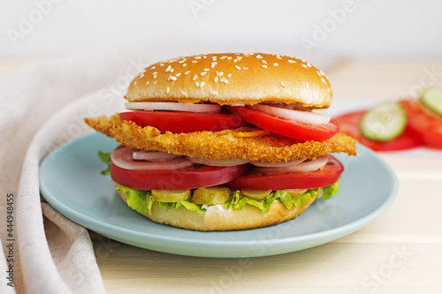 hamburger on a plate with tomato