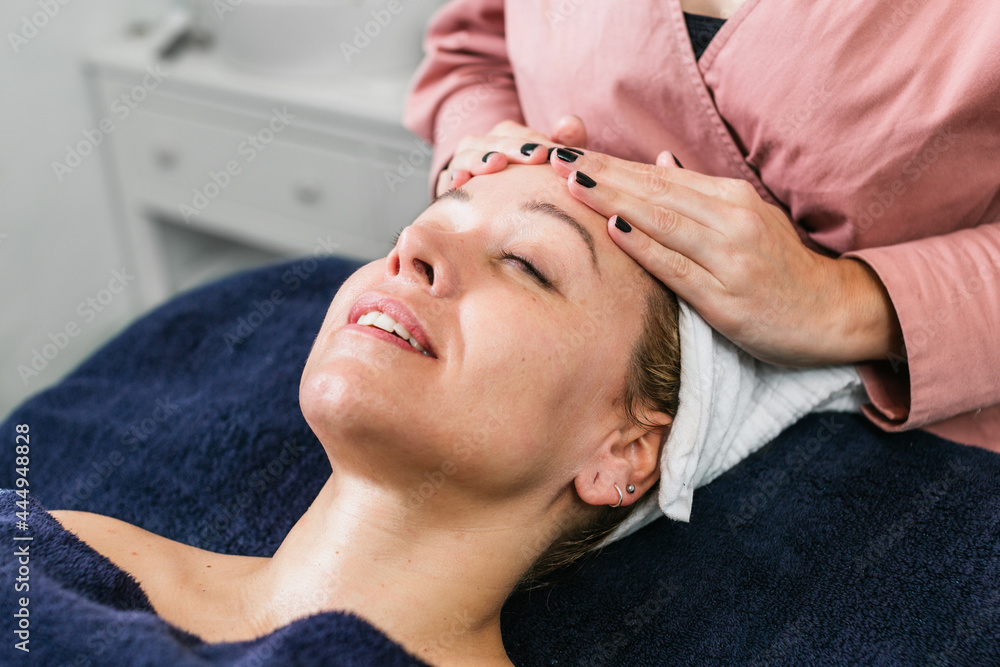 Anonymous masseuse doing massage for woman in spa salon Anonymous masseuse doing massage for woman in spa salon
