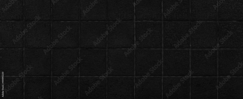 Fototapeta premium Panorama of Black granite tiled wall with vintage pattern texture and background seamless