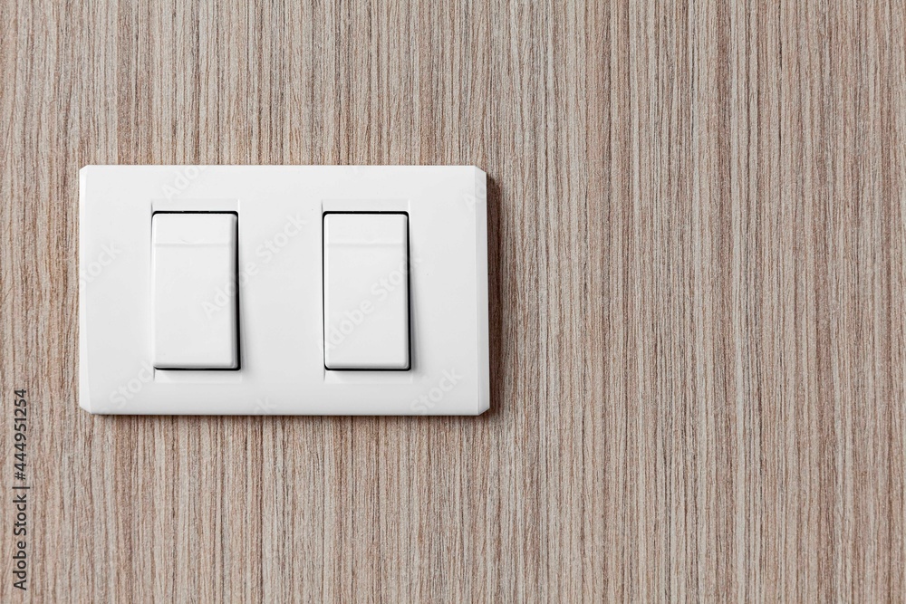 White plastic light switch at the head of the bedroom bed White plastic light switch at the head of the bedroom bed
