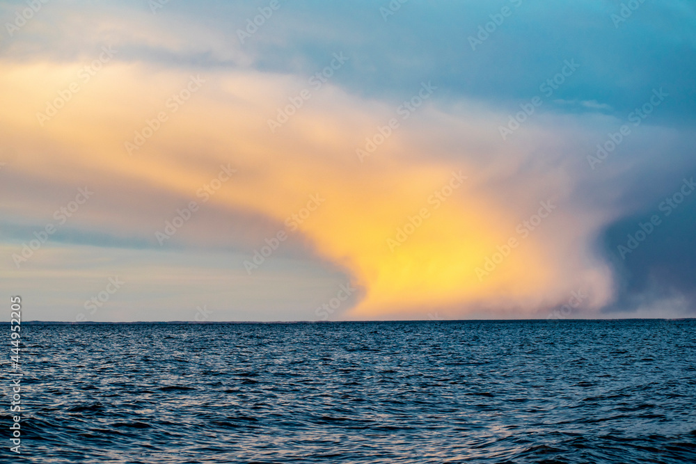 Magnificent view of the beautiful clouds in the setting sun over the sea. Summer vacation concept. Magnificent view of the beautiful clouds in the setting sun over the sea. Summer vacation concept.