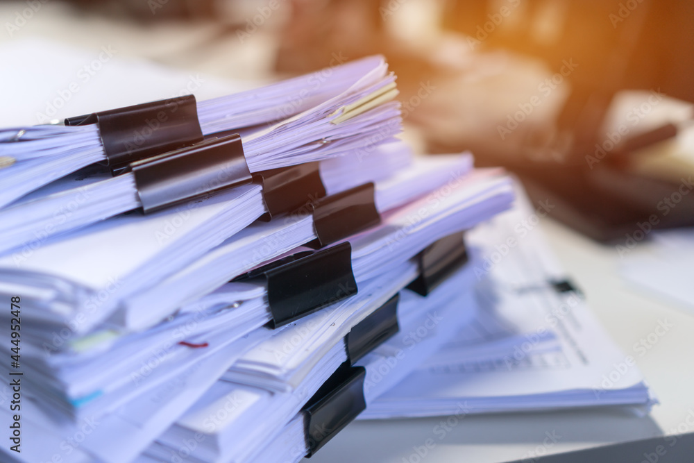 Accounting planning budget concept : Business paper in offices working for arranging documents unfinished stack of document papers with pen, clip papers on busy office desk Accounting planning budget concept : Business paper in offices working for arranging documents unfinished stack of document papers with pen, clip papers on busy office desk