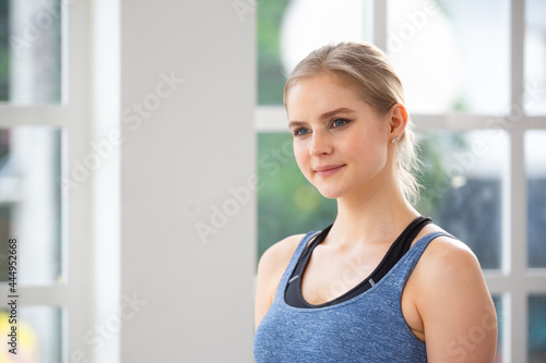 Portrait of Caucasian sporty woman in sportswear standing in yoga studio. attractive people healthy lifestyle. copy space
