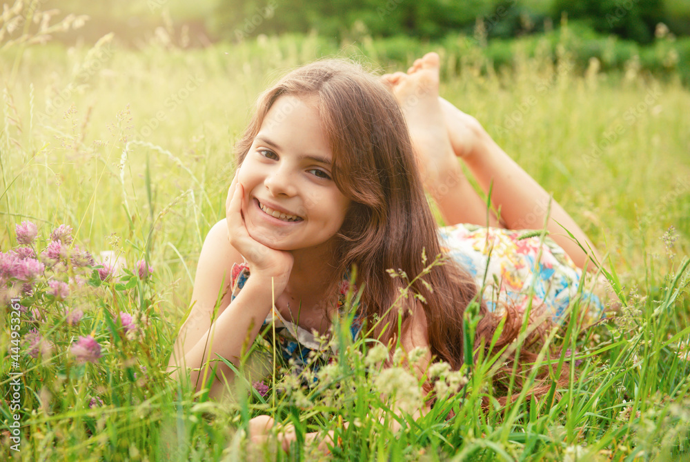 attractive white teenage girl lies on the grass attractive white teenage girl lies on the grass