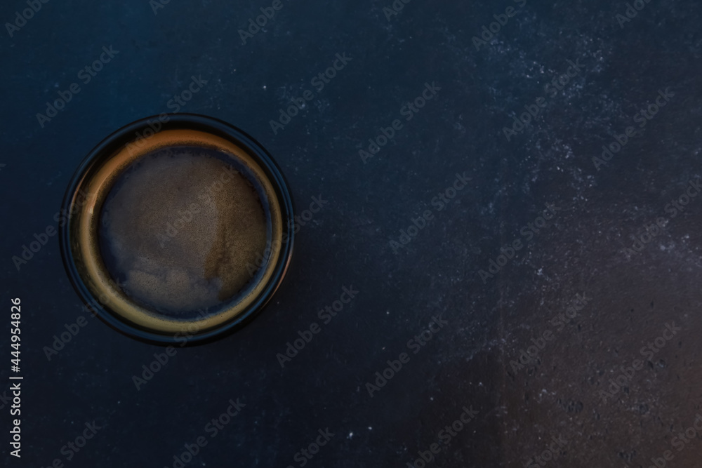 Black coffee cup top view. Dark mug of espresso or Americano on concrete table background. For coffee shop templates, cafe, morning concept Black coffee cup top view. Dark mug of espresso or Americano on concrete table background. For coffee shop templates, cafe, morning concept