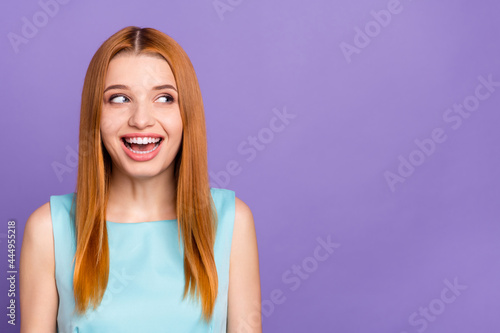 Photo of attractive curious young woman look empty space good mood isolated on pastel violet color background