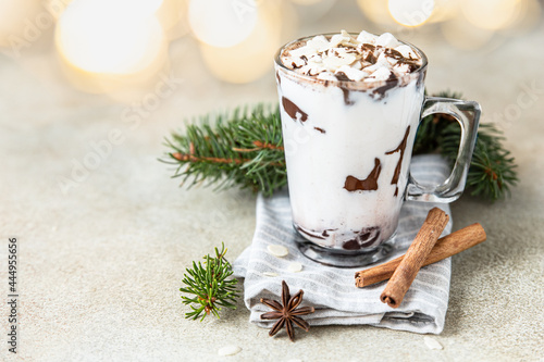 Hot chocolate or cocoa drink with marshmallow. Winter holiday composition with cinnamon sticks, anise and garland.