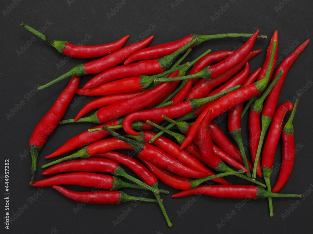 chili peppers on a black background