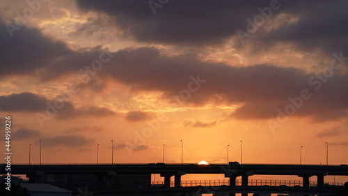The sunset view with the highway bridge as background and the colorful sky in the city