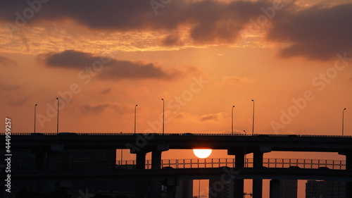 The sunset view with the highway bridge as background and the colorful sky in the city