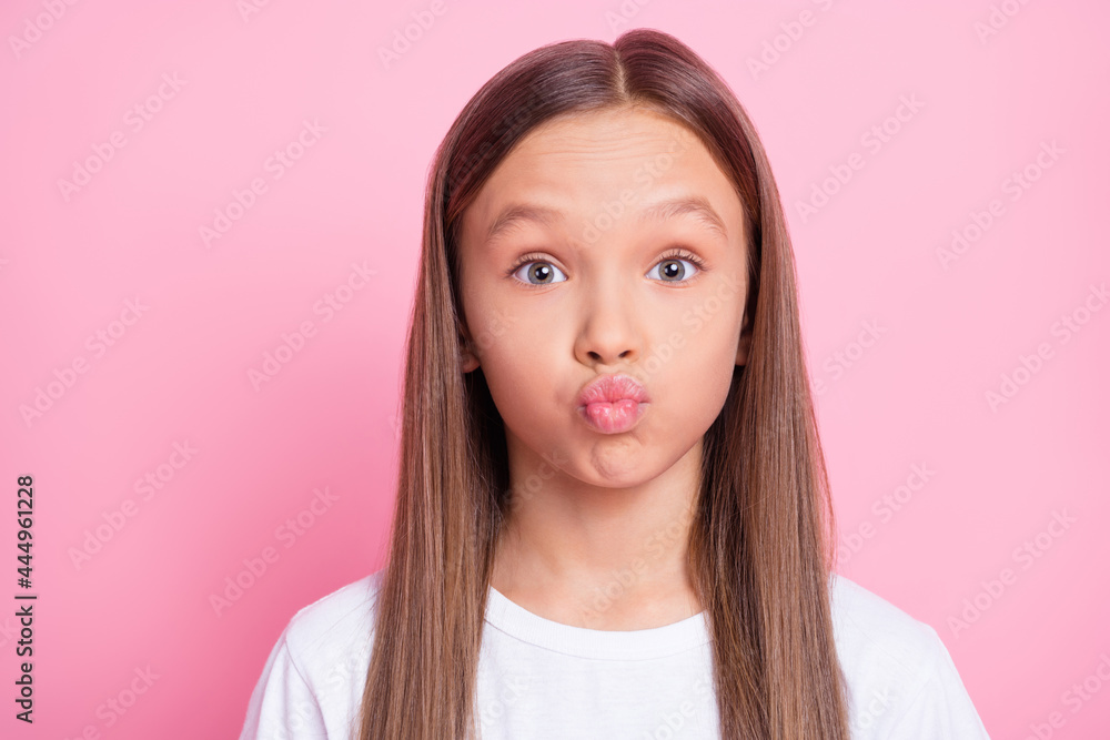 Close-up portrait of lovely funny cheerful preteen girl sending you air kiss isolated over pink pastel color background Close-up portrait of lovely funny cheerful preteen girl sending you air kiss isolated over pink pastel color background