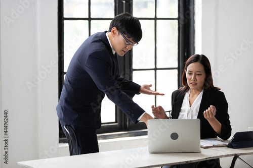 furious two businesspeople arguing strongly after making a mistake at work in office photo