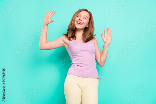 Photo of funny blond hairdo small girl dance wear violet top isolated on teal color background © deagreez