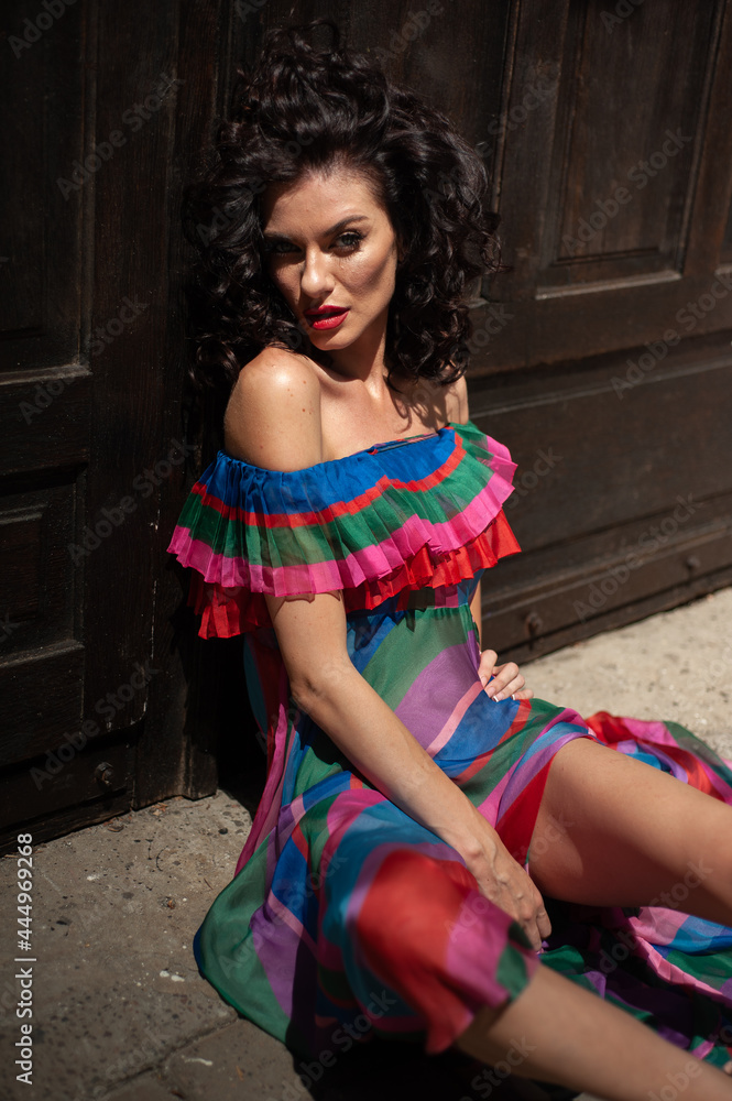 Attractive sensual woman wearing summer dress in the old city