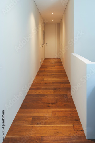 White hallway with spotlights in a stylish modern home. White walls  perfect for your text