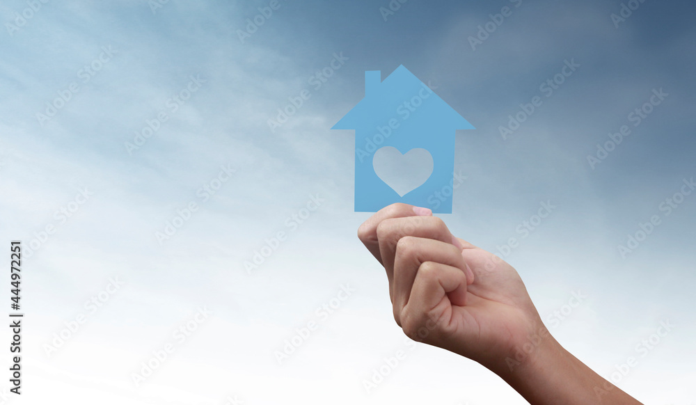 Naklejka premium Hands holding paper house, family home protecting insurance concept