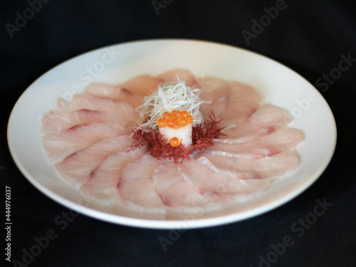 Suzuki Usuzukuri or White Snapper sliced with Ponzu Sauce and Lemon sliced.