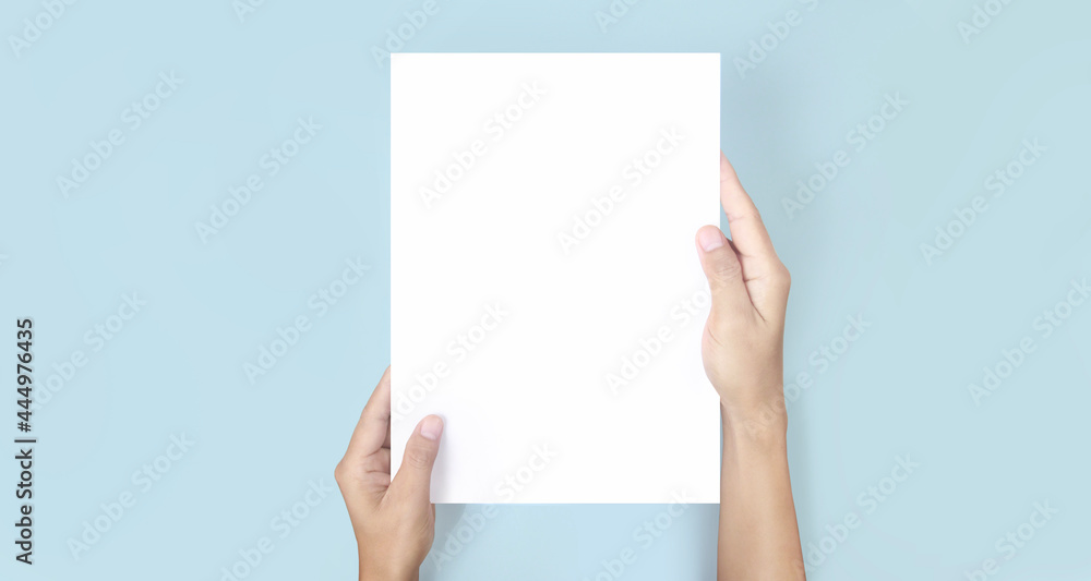 Hands holding paper blank for letter paper Hands holding paper blank for letter paper