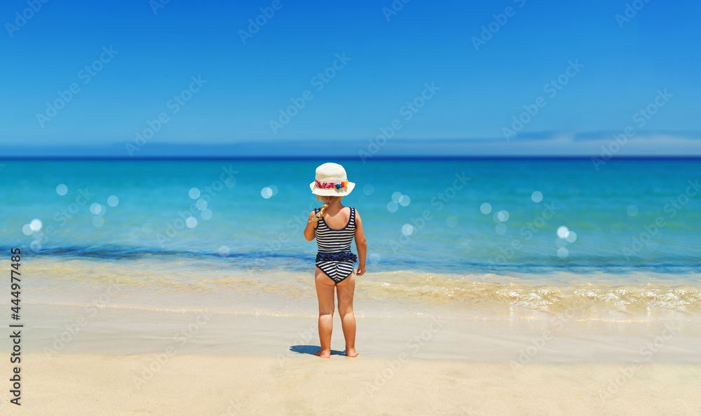 a cute girl is playing on the beach on vacation