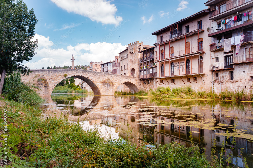 Valderrobres, Spain - July 7, 2021: Stone bridge over the river makes the entrance to the old medieval city of Valderrobres.