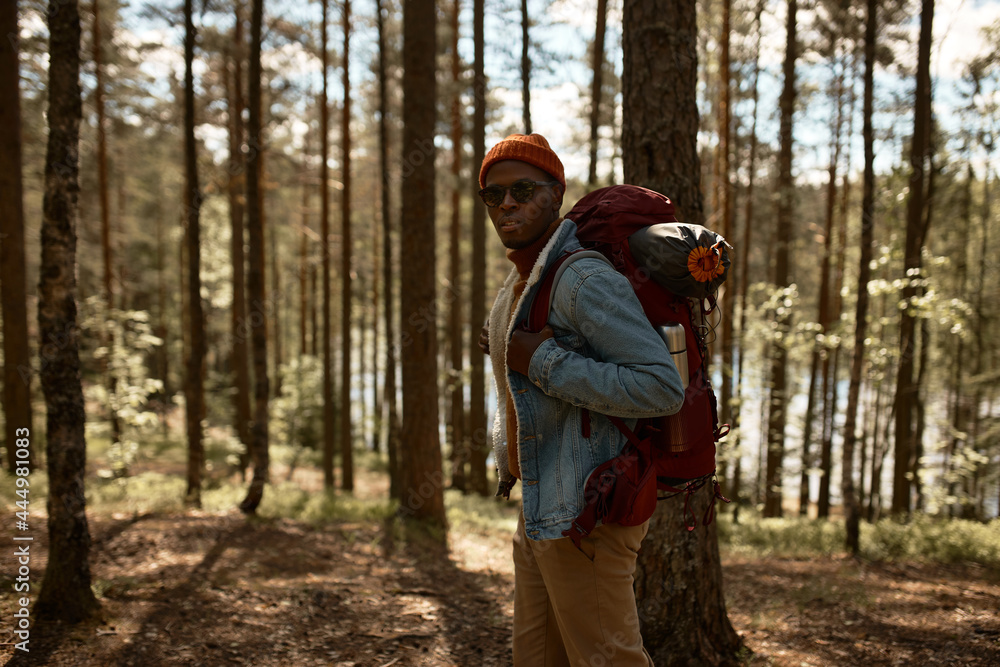 Skilled traveler with backpack exploring untouched nature. Ready for adventure, travelling alone, find peace for body and soul. Total relaxation, virgin nature, new experience concept Skilled traveler with backpack exploring untouched nature. Ready for adventure, travelling alone, find peace for body and soul. Total relaxation, virgin nature, new experience concept