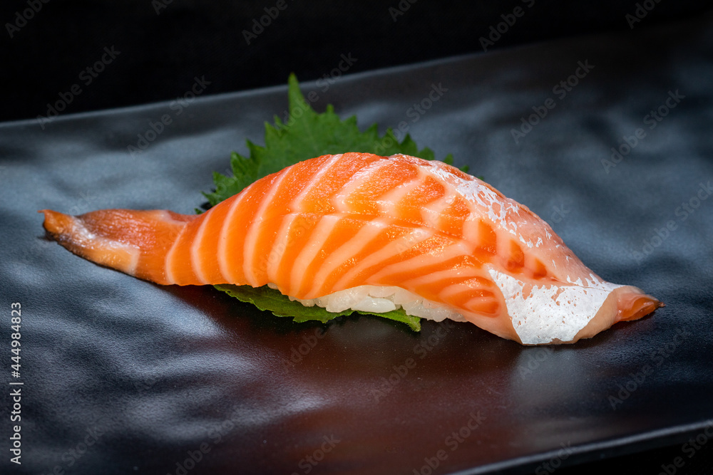 Delicious Sushi Nigiri with Salmon (Sake) on black background. Traditional Japanese cuisine. Delicious Sushi Nigiri with Salmon (Sake) on black background. Traditional Japanese cuisine.