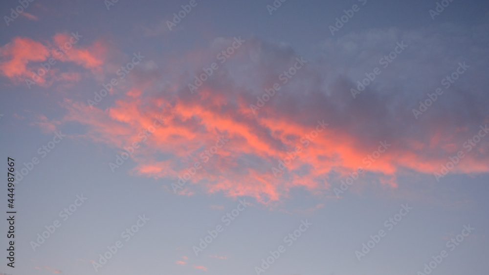 Pink cloud in the evening sunset with purple lining