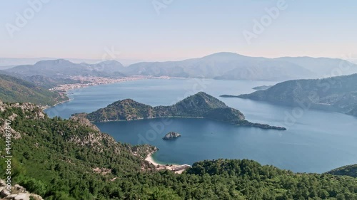 Flying over a cliff in the turkish bay of Marmaris overlooking the island and the city