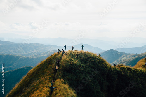 hiking group on mountain at Khao Chang Phuak, Thongphaphoom National Park, Kanchanaburi Province, Thailand. Subject is blurred, noise and color effect. © suparat1983