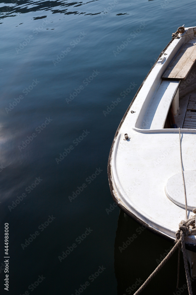 a white boat in blue water. close-up