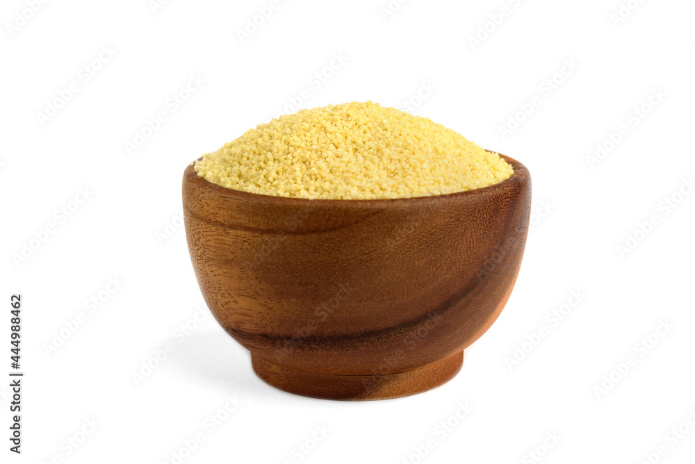 Dry couscous in wooden bowl isolated on white background. Dry couscous in wooden bowl isolated on white background.