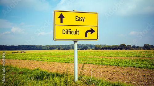 Fotografi Street Sign to Easy versus Difficult