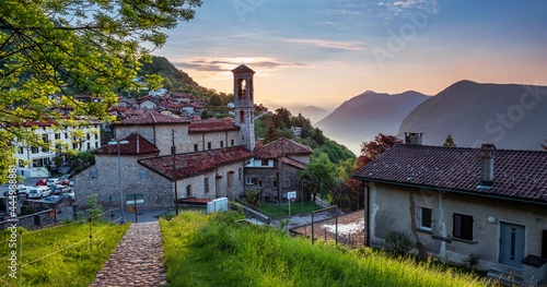 Picturesque Bre village situated on slope of the mountain of Monte Bre. Beautiful view of village and tops of mountains. photo