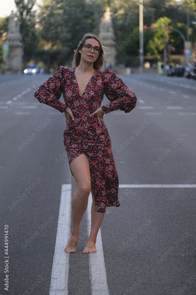 Young fashion woman looking while posing for the camera on a street in Barcelona