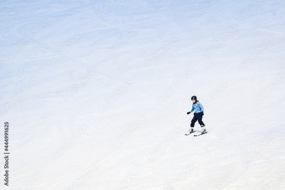 Young caucasian Teenager boy with no jacket skiing down hill on ski slope Young caucasian Teenager boy with no jacket skiing down hill on ski slope
