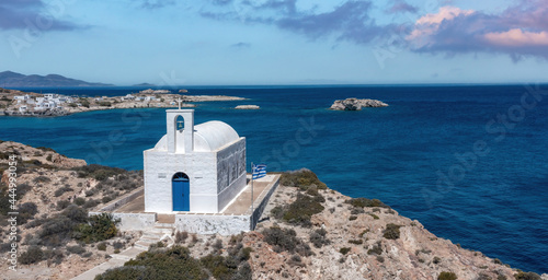 Greece Kimolos island, Cyclades. White small church at Psathi port, aerial drone view. photo