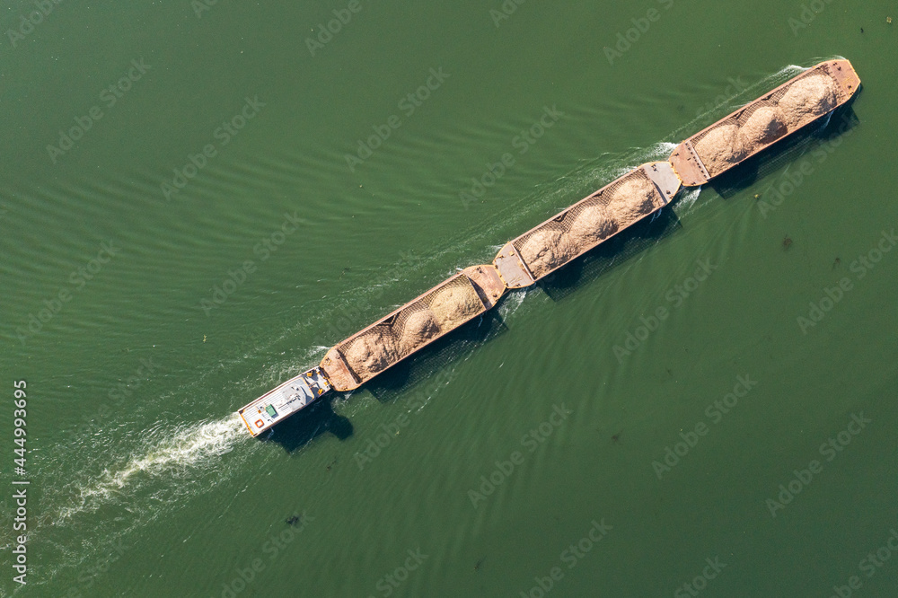 barge transporting commodities in river - Tiete Waterway