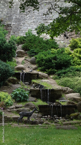 stone fountains with running water and a bronze deer in front, Tallinn, Estonia