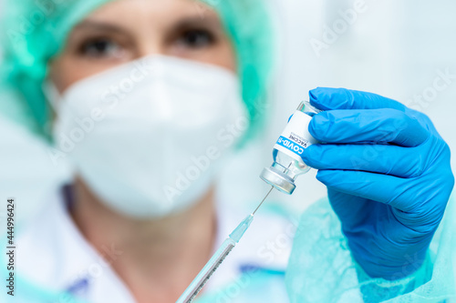 Doctor, woman nurse, scientist hand in white gloves holding bottle, syringe coronavirus, covid-19 vaccine disease preparing for a child, adult, man and woman vaccination shot medicine and drug concept