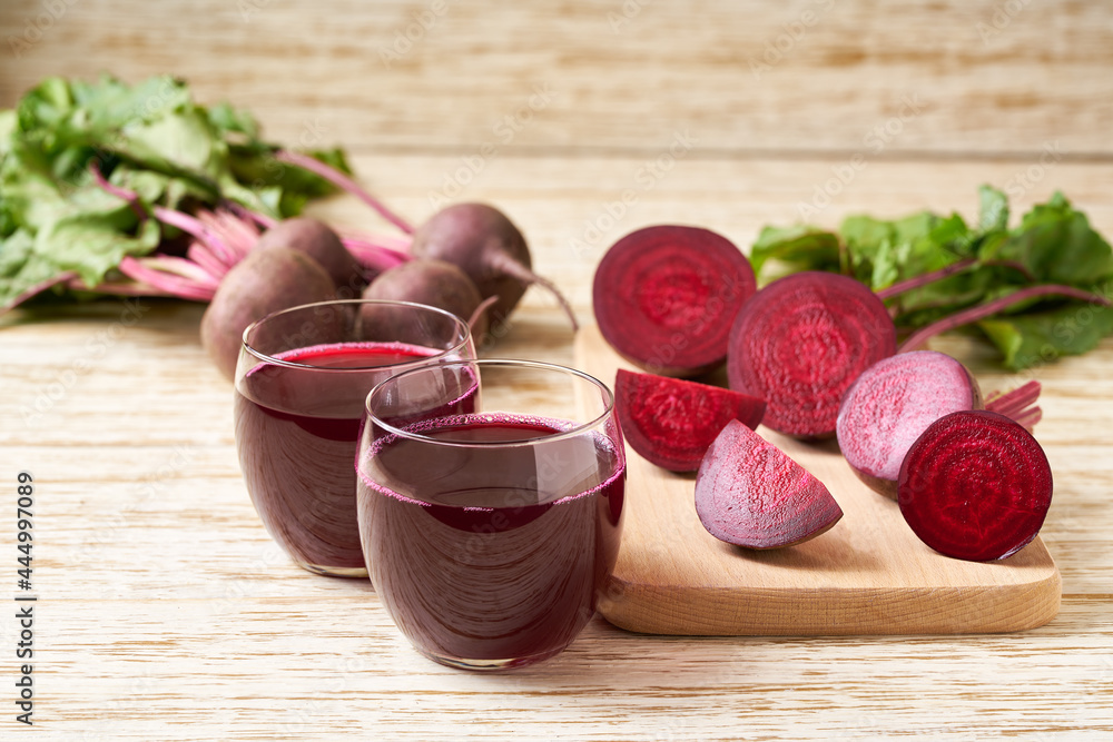 Fresh beetroot smoothies and vegetables on a wooden table,close-up.